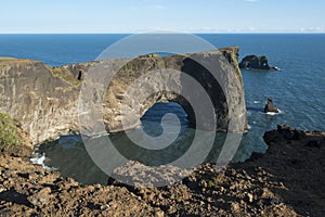 Rock formation in the ocean, Dyrholaey rock arch, South Iceland