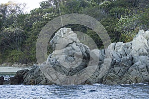 rock formation over the sea in the shape of a lion, bahias de huatulco, Oaxaca Mexico