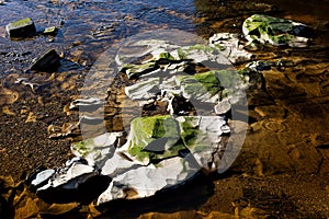 Rock Formation and Stones in a River Bed at Low Water