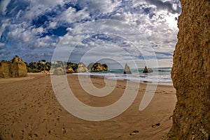 Rock formation and the view on the beach of Tres Irmaos in Alvor, PortimÃ£o, Algarve, Portugal, Europe. Praia dos Tres Irmaos