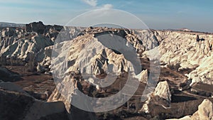 Rock formations and barren terrain in Cappadocia Turkey - Low angle parallax orbit aerial