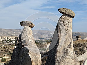 rock formations on a cliff with trees and hills in the background