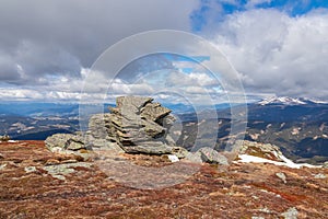 Rock formations with scenic view on snowcapped Ameringkogel on Packalpe seen from Steinerne Hochzeit in Saualpe mountains photo
