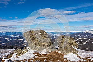 Rock formations with scenic view on snowcapped Ameringkogel on Packalpe seen from Steinerne Hochzeit in Saualpe mountains photo