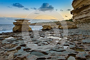 Rock formations at St. Peter`s Pool at sunset near Marsaxlokk, Malta.