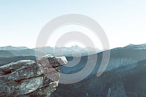 Rock in front of mountain landscape