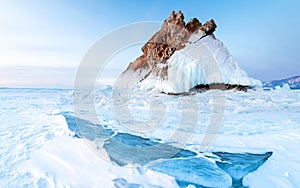 Rock on the frozen Baikal lake in winter