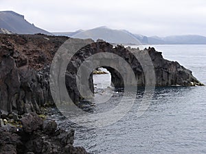 Rock gate on beach of Jan Mayen island