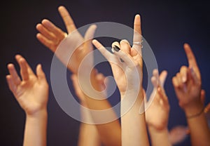 Rock on gesture, hands and music festival with people, celebration and party with entertainment and night. Concert