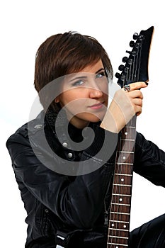 Rock girl in leather outfit with electric guitar