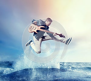 Rock guitarist with bas-guitar, snapshot in a jump photo