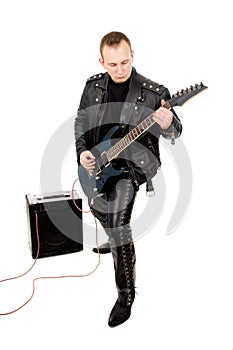 Rock guitarist in leather garments, plays guitar