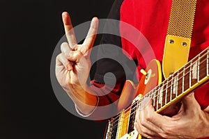 Rock guitarist playing the guitar on dark background