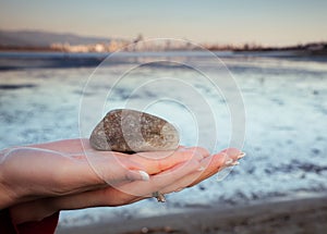 Rock held in palm of woman's hand