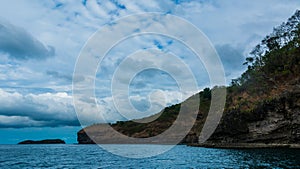 Rock Island over scenic blue sea water