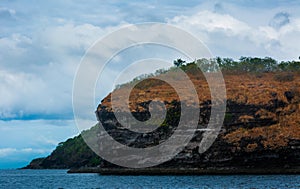 Rock Island over scenic blue sea water