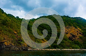 Rock Island over scenic blue sea water