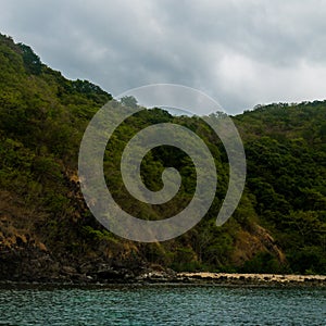 Rock Island over scenic blue sea water