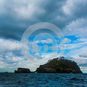 Rock Island over scenic blue sea water