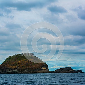 Rock Island over scenic blue sea water