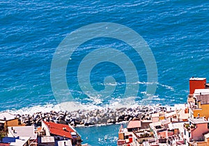 Rock jetty, protecting a small Italian village, from pounding surf , Mediterranean sea