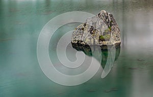 A rock in the lake of Julierpass in Switzerland