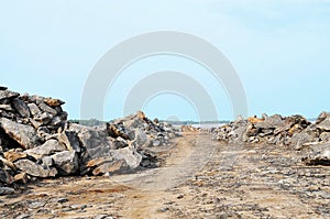 Rock lined road to the sea