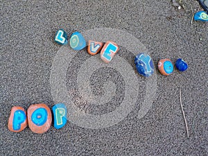 Rock `Love You Pop` sign on pavement