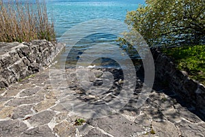 Rock-made path down to clear lake water