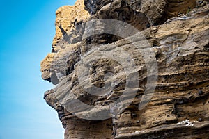 A rock with many holes eroded by the sea waves photo