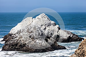 Rock mountain in seashore at Ocean Beach in San Francisco, California photo