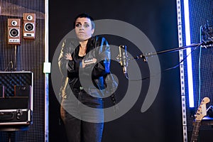 Rock musician doing i dont know gesture while standing in front of microphone preparing to sing heavy metal song