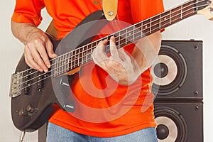 Rock musician playing the electric bass guitar