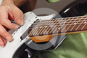 Rock musician playing the electric guitar close up