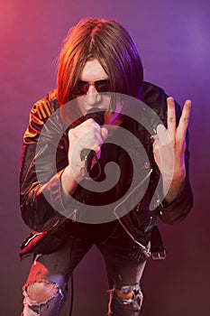 Rock musician singing in microphone