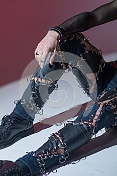 Rock musician in torn leather clothes