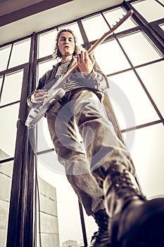 Rock musician wearing massive leather boots playing music