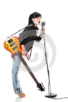 Rock-n-roll girl holding a guitar singing