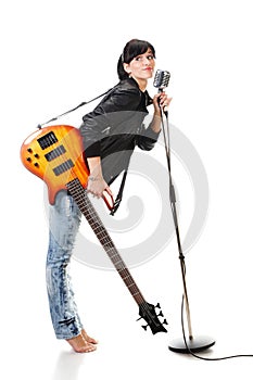 Rock-n-roll girl holding a guitar singing