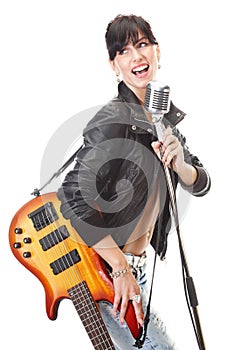 Rock-n-roll girl holding a guitar singing into ret