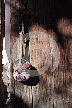 a rock that has some sort of face in it hanging from a string photo