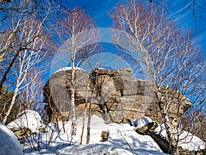 A rock with an Orthodox cross on mountain Church in the winter in Belokurikha, Russia