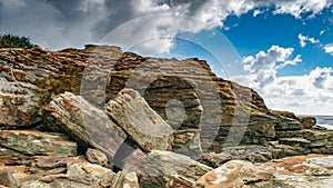 A rock outcrop by the sea shows the power of the sea