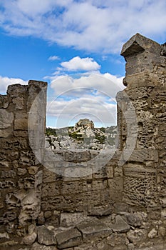 Rock outcropping against a blue sky framed by an opening in a wa