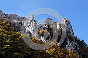 Rock outcroppings in autumn, with the moon photo