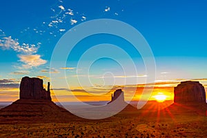 Rock outcrops of Monument Valley silhouetted ar sunset