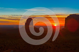 Rock outcrops of Monument Valley silhouetted ar sunset