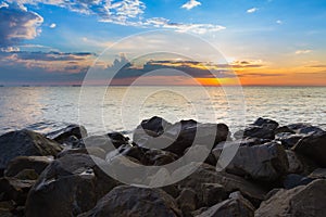 Rock over the beach skyline with sunset sky