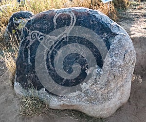 Rock painting aka petroglypgs at the field in Cholpon-Ata, Issyk-kul, Kyrgyzstan