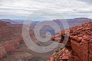 Rock with panoramic aerial view from South Kaibab hiking trail at South Rim of Grand Canyon National Park, Arizona, USA